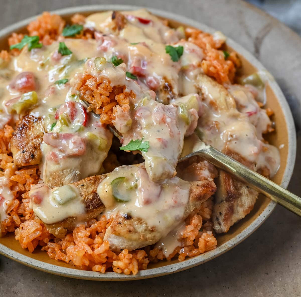 This Queso Smothered Chicken is a comforting, flavor-packed meal that makes everyone at the table ask for seconds — Pollo con Queso is it. This dish brings together juicy sautéed chicken, homemade Spanish rice, and a rich, creamy queso sauce made from scratch.  A hearty, cheesy, restaurant-style dish you can make right at home — and better than takeout.