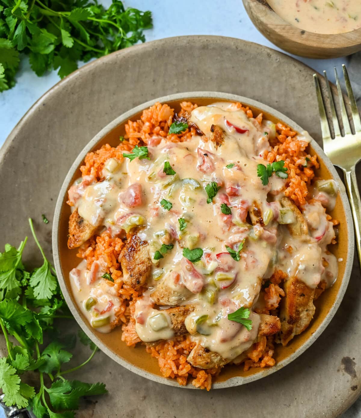 This Queso Smothered Chicken is a comforting, flavor-packed meal that makes everyone at the table ask for seconds — Pollo con Queso is it. This dish brings together juicy sautéed chicken, homemade Spanish rice, and a rich, creamy queso sauce made from scratch.  A hearty, cheesy, restaurant-style dish you can make right at home — and better than takeout.