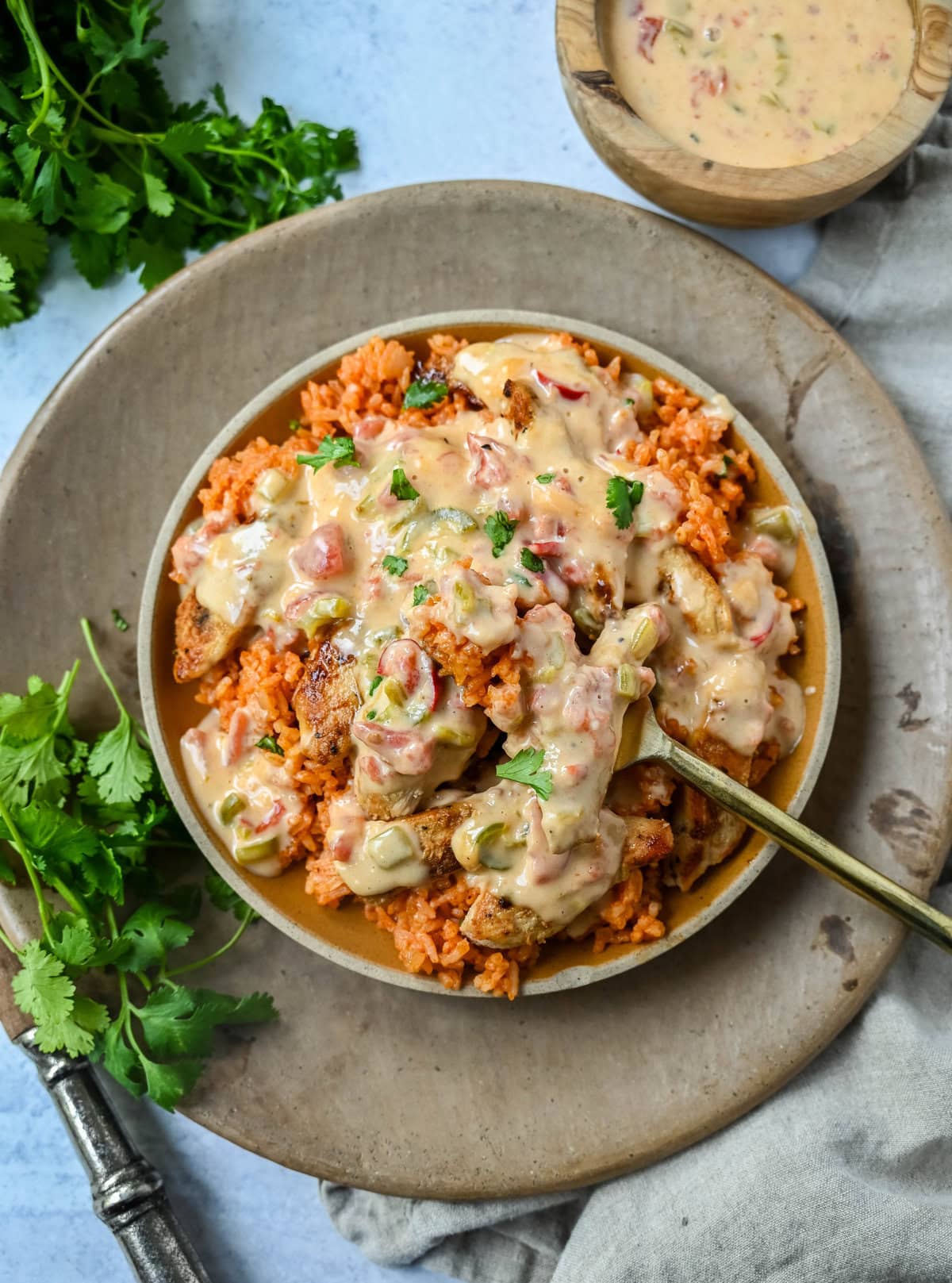 This Queso Smothered Chicken is a comforting, flavor-packed meal that makes everyone at the table ask for seconds — Pollo con Queso is it. This dish brings together juicy sautéed chicken, homemade Spanish rice, and a rich, creamy queso sauce made from scratch.  A hearty, cheesy, restaurant-style dish you can make right at home — and better than takeout.