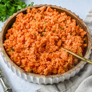 This easy Spanish Rice Recipe — also known as Mexican rice — is a flavorful, vibrant side dish made with sautéed onions, long-grain rice, Mexican spices, and fresh tomato sauce. This is the best Spanish rice recipe and is so easy to make!