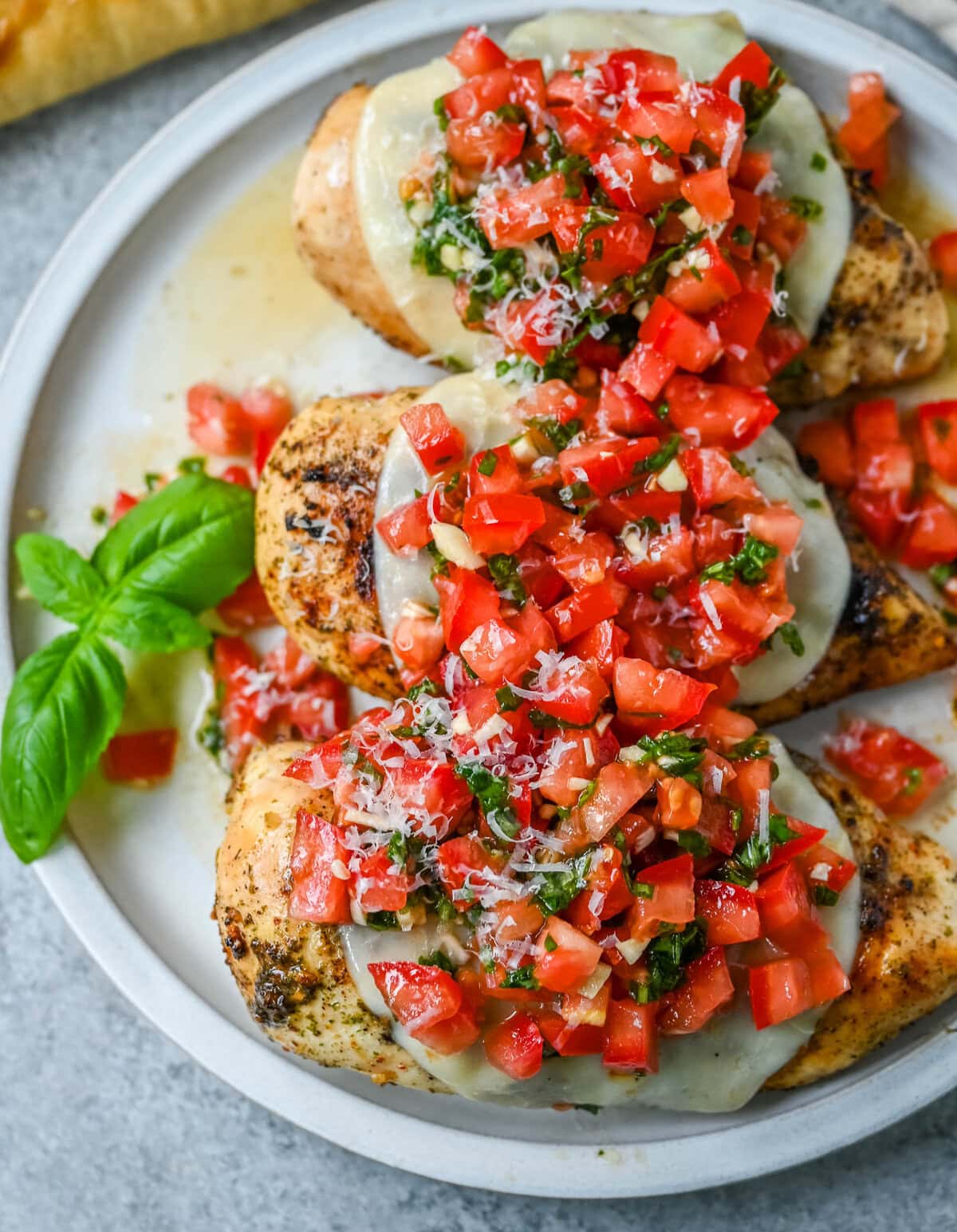 Bruschetta Grilled Chicken combines tender Italian grilled chicken breasts with juicy, garlicky tomato bruschetta, creamy melted mozzarella cheese, and a drizzle of balsamic glaze. 