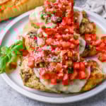 Bruschetta Grilled Chicken combines tender Italian grilled chicken breasts with juicy, garlicky tomato bruschetta, creamy melted mozzarella cheese, and a drizzle of balsamic glaze.