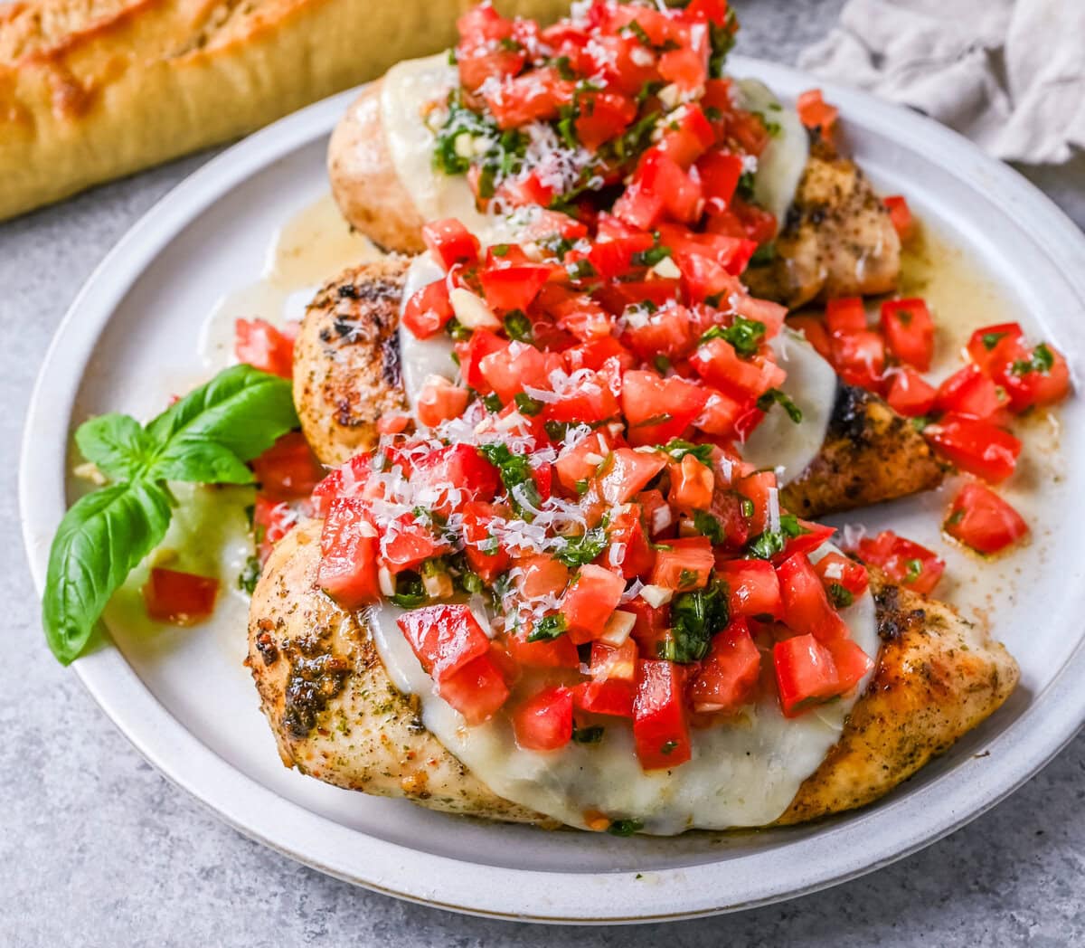 Bruschetta Grilled Chicken combines tender Italian grilled chicken breasts with juicy, garlicky tomato bruschetta, creamy melted mozzarella cheese, and a drizzle of balsamic glaze. 