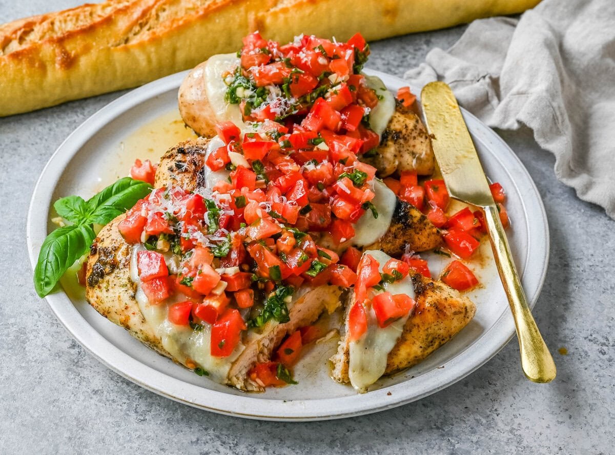 Bruschetta Grilled Chicken combines tender Italian grilled chicken breasts with juicy, garlicky tomato bruschetta, creamy melted mozzarella cheese, and a drizzle of balsamic glaze. 