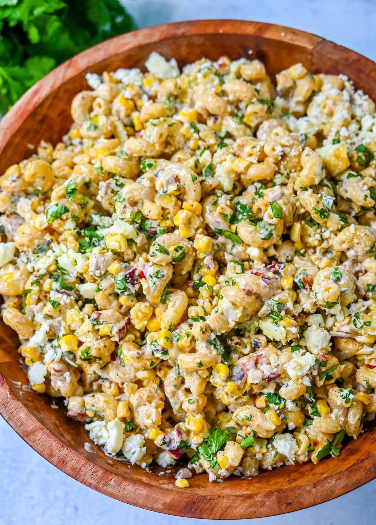 This Mexican Street Corn Pasta Salad is made with fresh corn, pasta, red onion, jalapeno, fresh cilantro, all tossed in a perfectly spiced dressing and topped with cotija cheese, Mexican spices, and fresh lime. It’s street food meets comfort food and it is so addictive. Perfect for a summer BBQ, potluck dish, or the perfect side dish, this Mexican Street Corn Pasta Salad delivers every time.