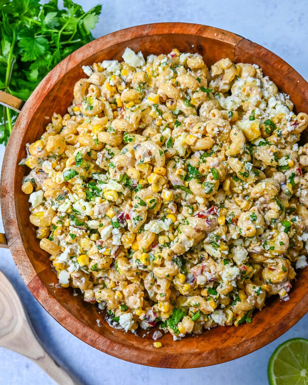 This Mexican Street Corn Pasta Salad is made with fresh corn, pasta, red onion, jalapeno, fresh cilantro, all tossed in a perfectly spiced dressing and topped with cotija cheese, Mexican spices, and fresh lime. It’s street food meets comfort food and it is so addictive. Perfect for a summer BBQ, potluck dish, or the perfect side dish, this Mexican Street Corn Pasta Salad delivers every time.