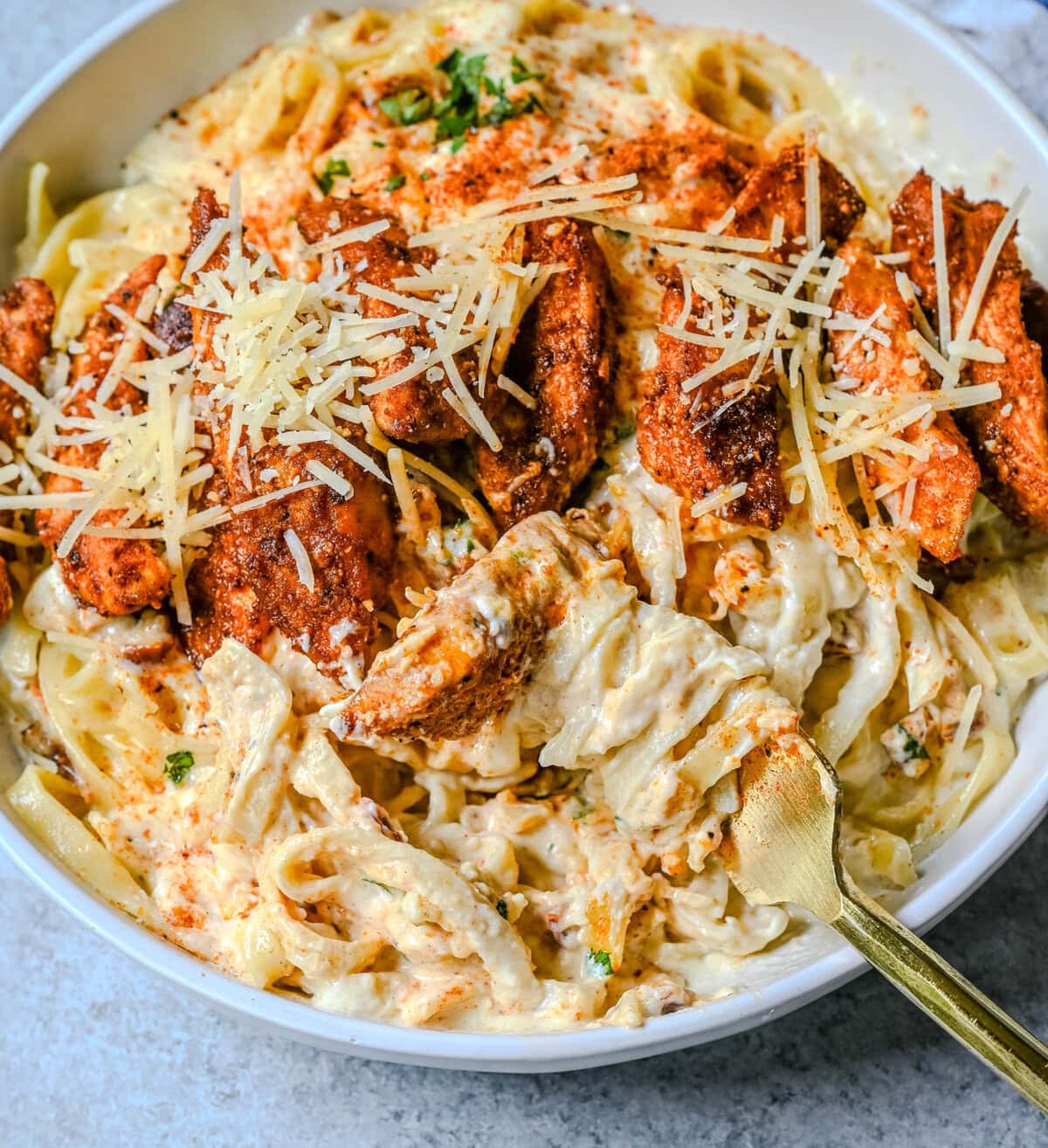 Cajun Chicken Alfredo is the ultimate comfort food with a spicy twist — tender blackened chicken, tossed in a silky Parmesan cream sauce over perfectly cooked pasta. Whether you're cooking for a weeknight dinner or a crowd, this dish delivers big time in flavor.