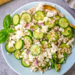This cucumber couscous salad is the ultimate fresh and easy Mediterranean inspired recipe that is light, flavorful, and ready in just 20 minutes. Fluffy couscous is tossed with crisp English cucumber, red onion, and creamy feta cheese then drizzled with a bright and tangy lemon vinaigrette that makes the best fresh side dish!