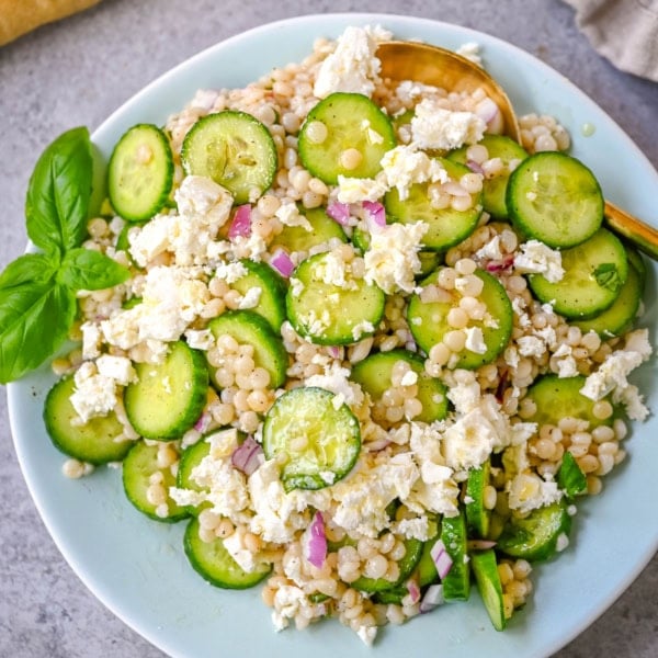 This cucumber couscous salad is the ultimate fresh and easy Mediterranean inspired recipe that is light, flavorful, and ready in just 20 minutes. Fluffy couscous is tossed with crisp English cucumber, red onion, and creamy feta cheese then drizzled with a bright and tangy lemon vinaigrette that makes the best fresh side dish!