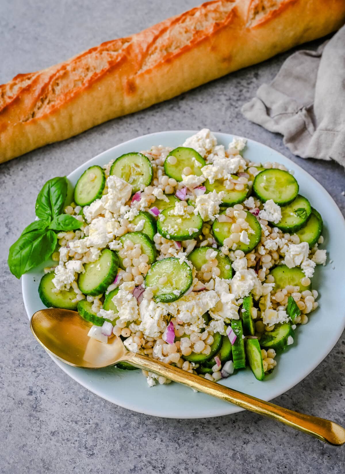 This cucumber couscous salad is the ultimate fresh and easy Mediterranean inspired recipe that is light, flavorful, and ready in just 20 minutes. Fluffy couscous is tossed with crisp English cucumber, red onion, and creamy feta cheese then drizzled with a bright and tangy lemon vinaigrette that makes the best fresh side dish!