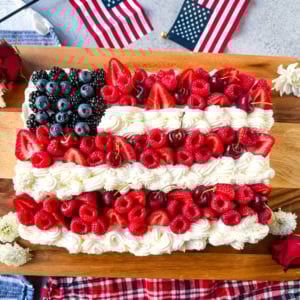 Best Flag Cake Recipe. Looking for a show-stopping, patriotic dessert that’s as delicious as it is beautiful? This American Flag Cake is your go-to recipe! It starts with a moist vanilla cake base, is topped with a lusciously light whipped cream cheese frosting, and decorated with fresh berries and cherries arranged like the U.S. flag.