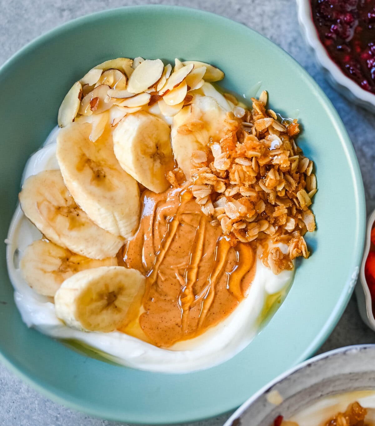 Chunky Monkey Greek Yogurt Bowl. Greek yogurt, peanut butter, bananas, granola, almonds, chocolate chips.