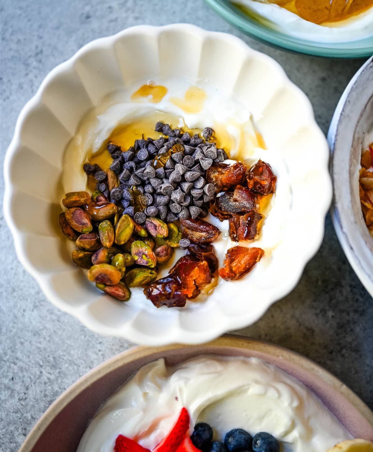 Dubai chocolate yogurt bowl. Greek yogurt, pistachios, dates, chocolate chips.