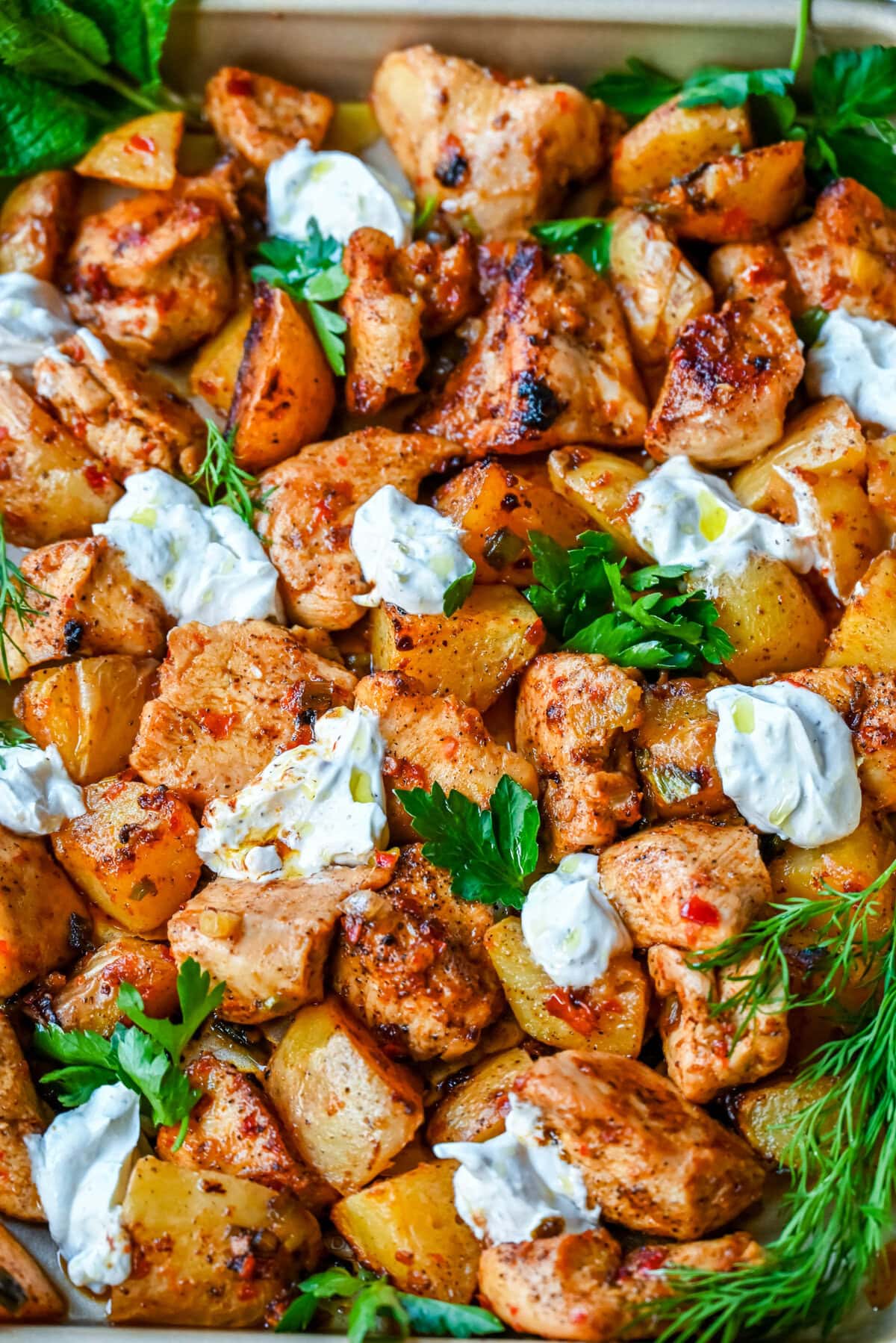 This Harissa Chicken and Roasted Potatoes recipe is a flavorful one-pan meal with juicy chicken breasts coated in a spicy harissa sauce and roasted with golden potatoes until perfectly crispy. A sprinkle of herbs at the end brings balance to this North African–inspired dish. It’s easy, satisfying, and the perfect simple weeknight dinner!