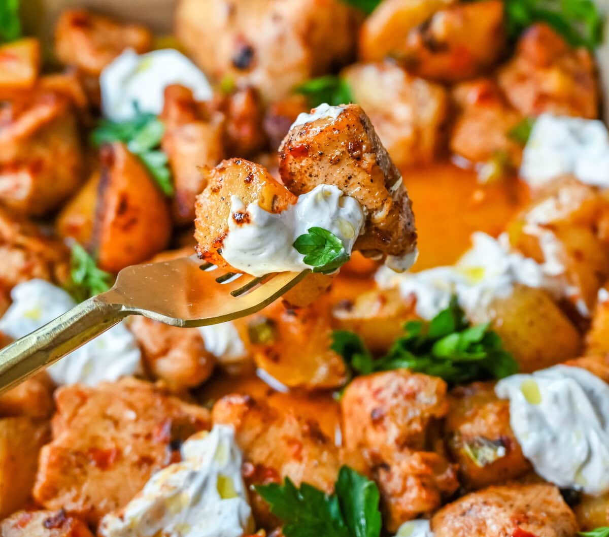 This Harissa Chicken and Roasted Potatoes recipe is a flavorful one-pan meal with juicy chicken breasts coated in a spicy harissa sauce and roasted with golden potatoes until perfectly crispy. A sprinkle of herbs at the end brings balance to this North African–inspired dish. It’s easy, satisfying, and the perfect simple weeknight dinner!