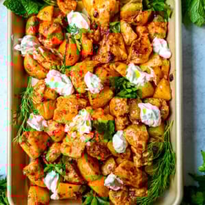 This Harissa Chicken and Roasted Potatoes recipe is a flavorful one-pan meal with juicy chicken breasts coated in a spicy harissa sauce and roasted with golden potatoes until perfectly crispy. A sprinkle of herbs at the end brings balance to this North African–inspired dish. It’s easy, satisfying, and the perfect simple weeknight dinner!