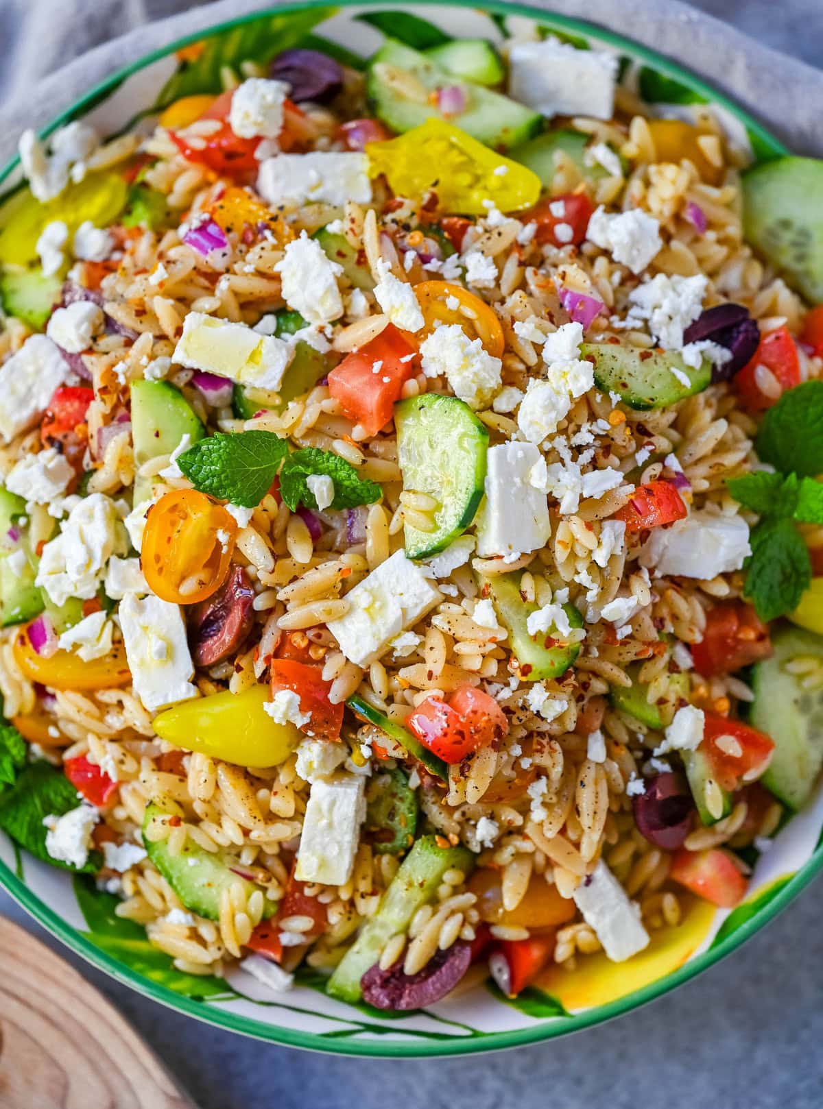 Fresh Mediterranean Orzo Salad made with a bright greek oregano dressing, orzo pasta, crisp cucumber, cherry tomatoes, red onion, feta cheese, and pepperoncinis. This greek orzo pasta salad recipe is perfect for summer or meal prep!