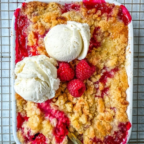 This easy Raspberry Crisp is a summer dessert favorite made with sweet, juicy raspberries and a buttery golden crumble topping. It’s the perfect way to use fresh raspberries when they’re in season, serve it warm with a scoop of vanilla ice cream for a quick fruit dessert perfect for summer.