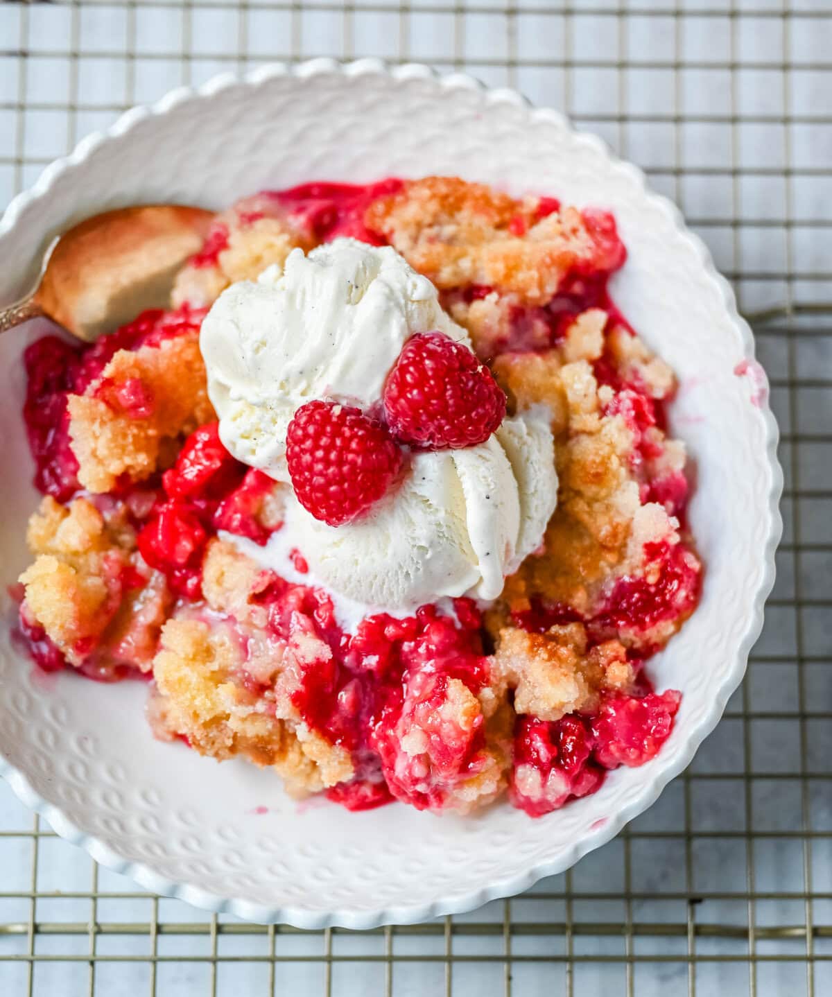 This easy Raspberry Crisp is a summer dessert favorite made with sweet, juicy raspberries and a buttery golden crumble topping. It’s the perfect way to use fresh raspberries when they’re in season, serve it warm with a scoop of vanilla ice cream for a quick fruit dessert perfect for summer.