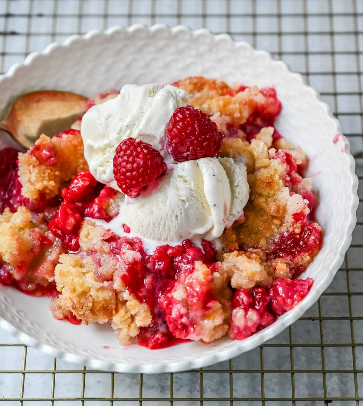 This easy Raspberry Crisp is a summer dessert favorite made with sweet, juicy raspberries and a buttery golden crumble topping. It’s the perfect way to use fresh raspberries when they’re in season, serve it warm with a scoop of vanilla ice cream for a quick fruit dessert perfect for summer.