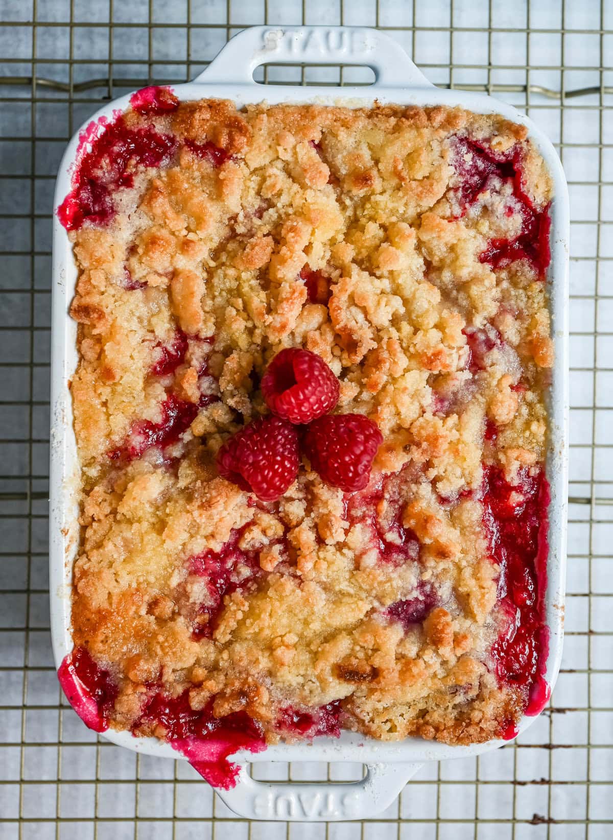 This easy Raspberry Crisp is a summer dessert favorite made with sweet, juicy raspberries and a buttery golden crumble topping. It’s the perfect way to use fresh raspberries when they’re in season, serve it warm with a scoop of vanilla ice cream for a quick fruit dessert perfect for summer.