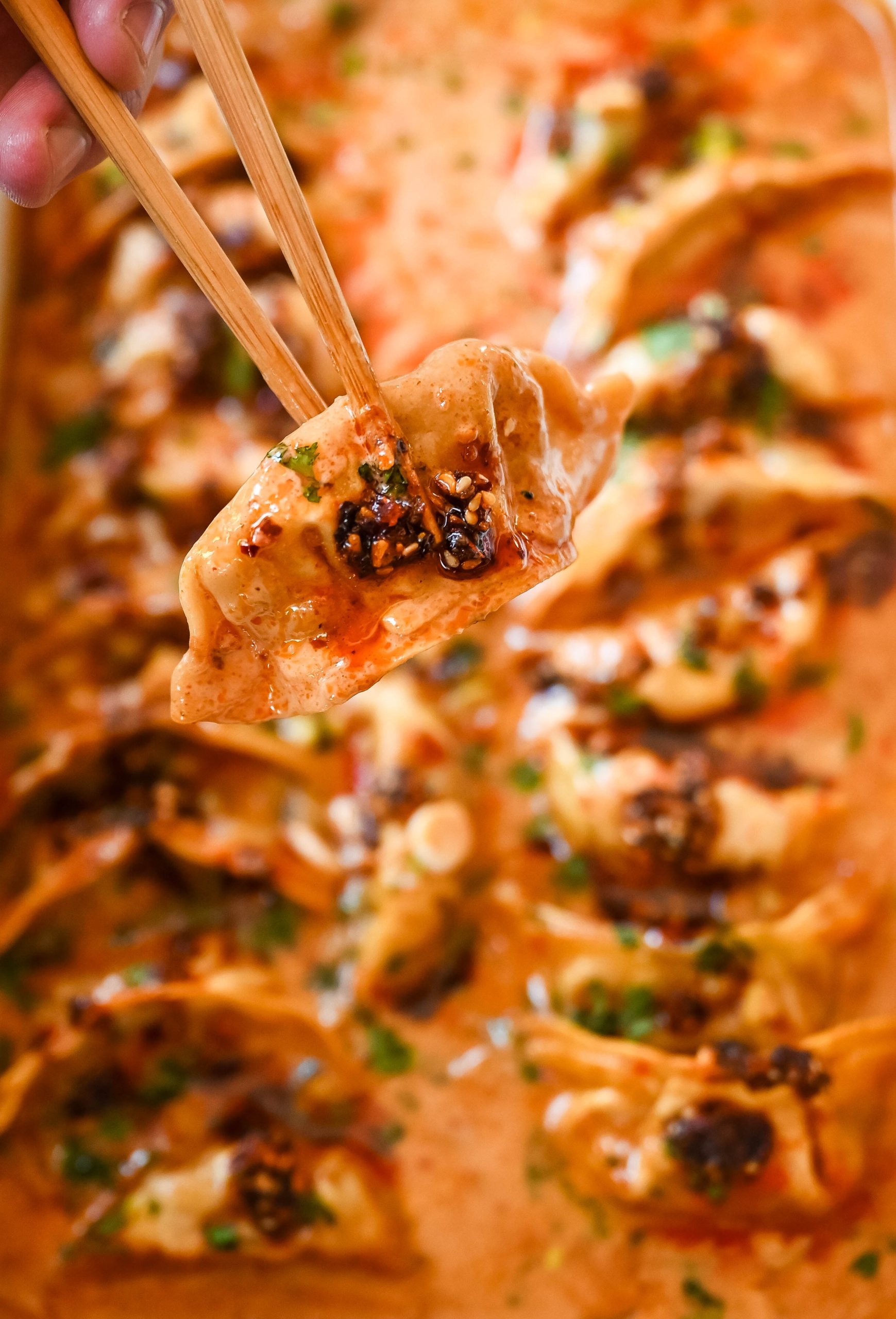 These viral baked dumplings from TikTok are the ultimate easy dinner hack! Crispy dumplings are baked in a creamy coconut curry sauce and topped with cilantro, chili crunch oil, and sesame seeds for the perfect mix of flavor and texture. This is an easy sheet pan dinner recipe!