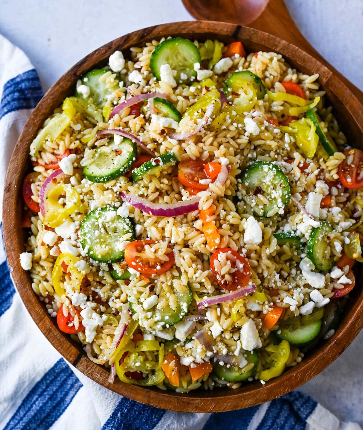 Fresh Mediterranean Orzo Salad made with a bright greek oregano dressing, orzo pasta, crisp cucumber, cherry tomatoes, red onion, feta cheese, and pepperoncinis. This greek orzo pasta salad recipe is perfect for summer or meal prep!
