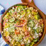 Fresh Mediterranean Orzo Salad made with a bright greek oregano dressing, orzo pasta, crisp cucumber, cherry tomatoes, red onion, feta cheese, and pepperoncinis. This greek orzo pasta salad recipe is perfect for summer or meal prep!
