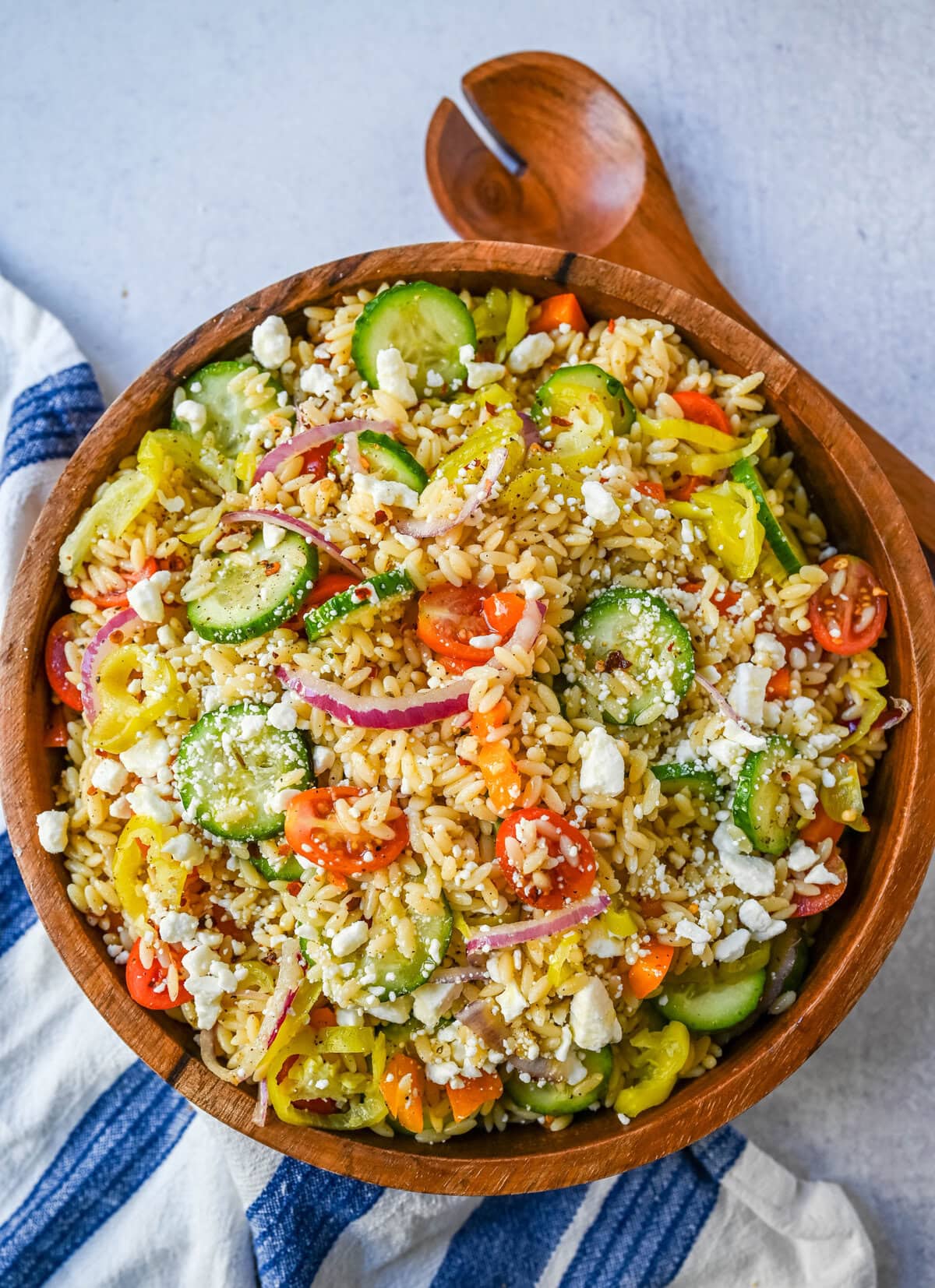 Fresh Mediterranean Orzo Salad made with a bright greek oregano dressing, orzo pasta, crisp cucumber, cherry tomatoes, red onion, feta cheese, and pepperoncinis. This greek orzo pasta salad recipe is perfect for summer or meal prep!