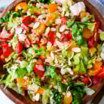 A fresh strawberry mandarin orange salad with candied almonds is the perfect summer side dish! Sweet strawberries, mandarin oranges, crunchy candied almonds, and a light homemade dressing.