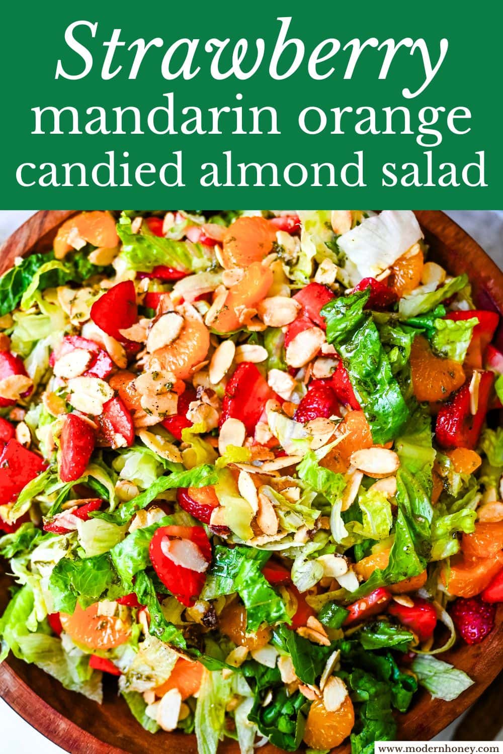 A fresh strawberry mandarin orange salad with candied almonds is the perfect summer side dish! Sweet strawberries, mandarin oranges, crunchy candied almonds, and a light homemade dressing.