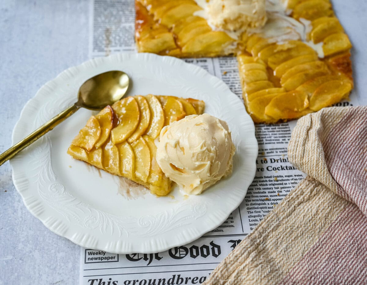 This homemade French Apple Tart recipe features a buttery crust, thinly sliced Granny Smith apples, and a golden apricot glaze for a bakery-style dessert. This Ina Garten French Apple Tart recipe is the best apple tart recipe, perfect for entertaining, holidays or any Fall baking.