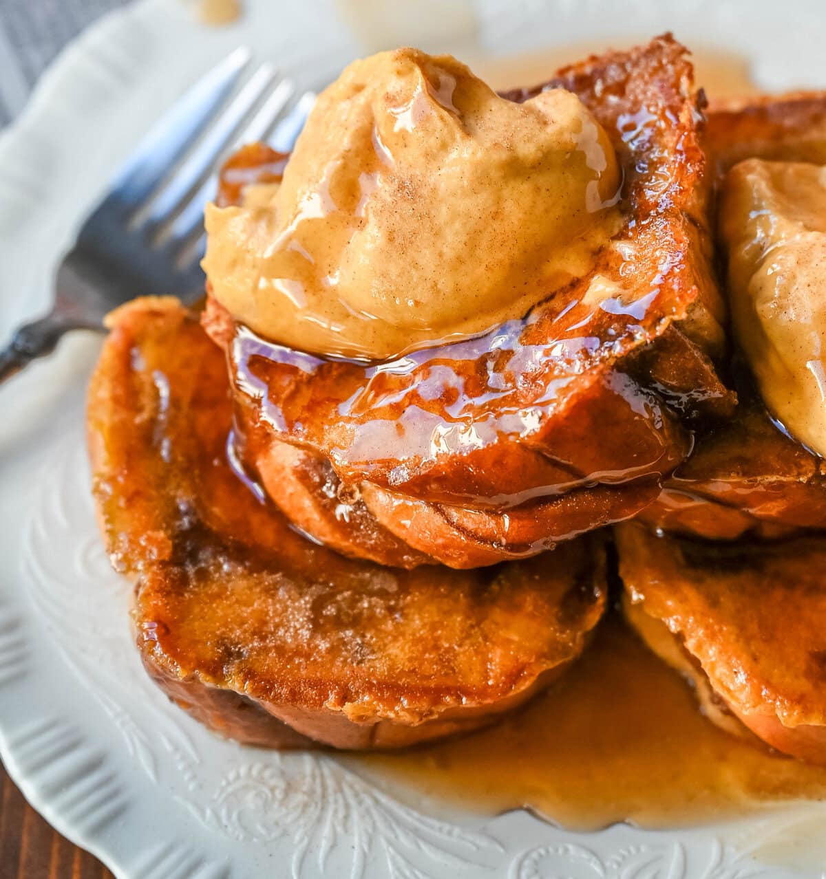 This Pumpkin French Toast is the perfect fall breakfast! Made with pumpkin puree, pumpkin spice, and thick slices of brioche cinnamon bread, it’s golden on the outside, soft inside, and topped with a dollop of sweet brown sugar pumpkin spice cream cheese.