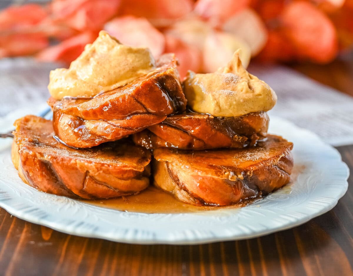 This Pumpkin French Toast is the perfect fall breakfast! Made with pumpkin puree, pumpkin spice, and thick slices of brioche cinnamon bread, it’s golden on the outside, soft inside, and topped with a dollop of sweet brown sugar pumpkin spice cream cheese.