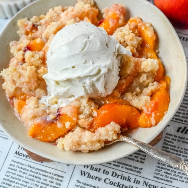 This Homemade Sugar Cookie Peach Cobbler is made with juicy peaches tossed in sugar and topped with a soft, buttery sugar cookie crust, then baked until golden. Serve it warm with a scoop of vanilla ice cream for the best peach cobbler recipe with a sugar cookie twist!