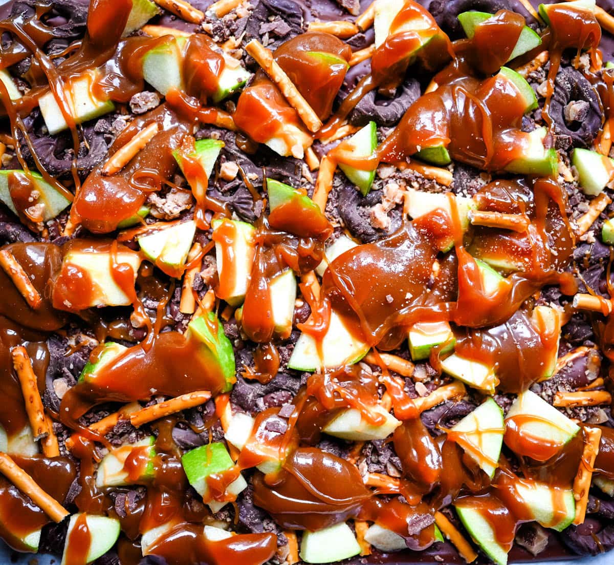 This Caramel Apple Bark is an easy no-bake Fall treat and made with fresh apples, buttery caramel, crunchy pretzels, and rich chocolate. This quick and easy Fall dessert is absolutely delicious and a crowd favorite!