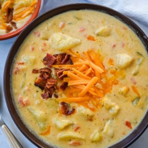 This creamy potato soup is the definition of comfort in a bowl made with buttery Yukon gold potatoes, crispy bacon, cheddar cheese, and a splash of heavy cream come together to make the richest, coziest soup ever. You will love this Potato Cheese Soup Recipe!