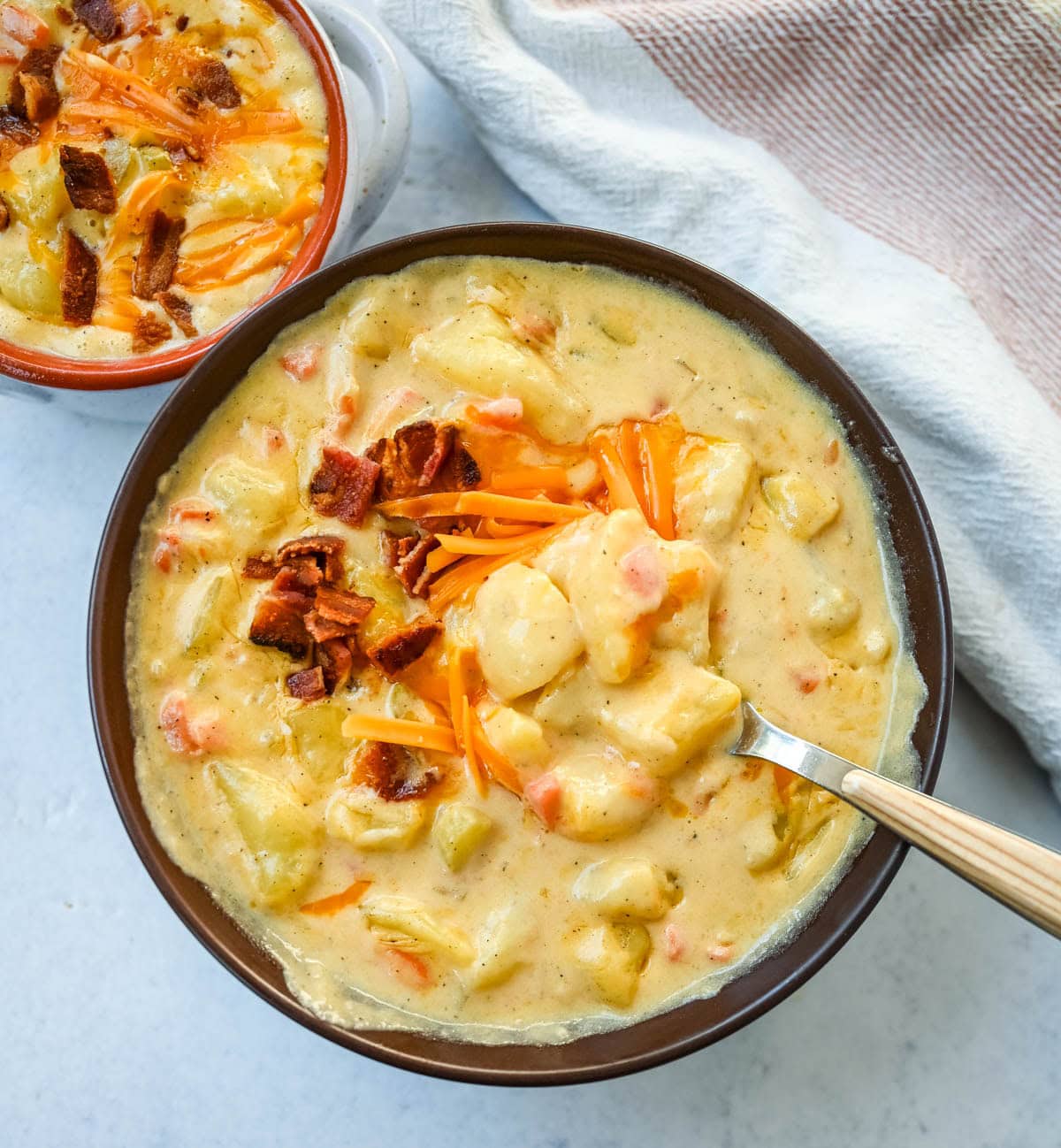 This creamy potato soup is the definition of comfort in a bowl made with buttery Yukon gold potatoes, crispy bacon, cheddar cheese, and a splash of heavy cream come together to make the richest, coziest soup ever. You will love this Potato Cheese Soup Recipe!
