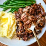 This French Onion Pot Roast recipe is made in your slow cooker for a set-it-and-forget-it meal packed with flavor. With sweet caramelized onions, beefy broth, and gooey Gruyère cheese, it's truly the best savory beef pot roast recipe!