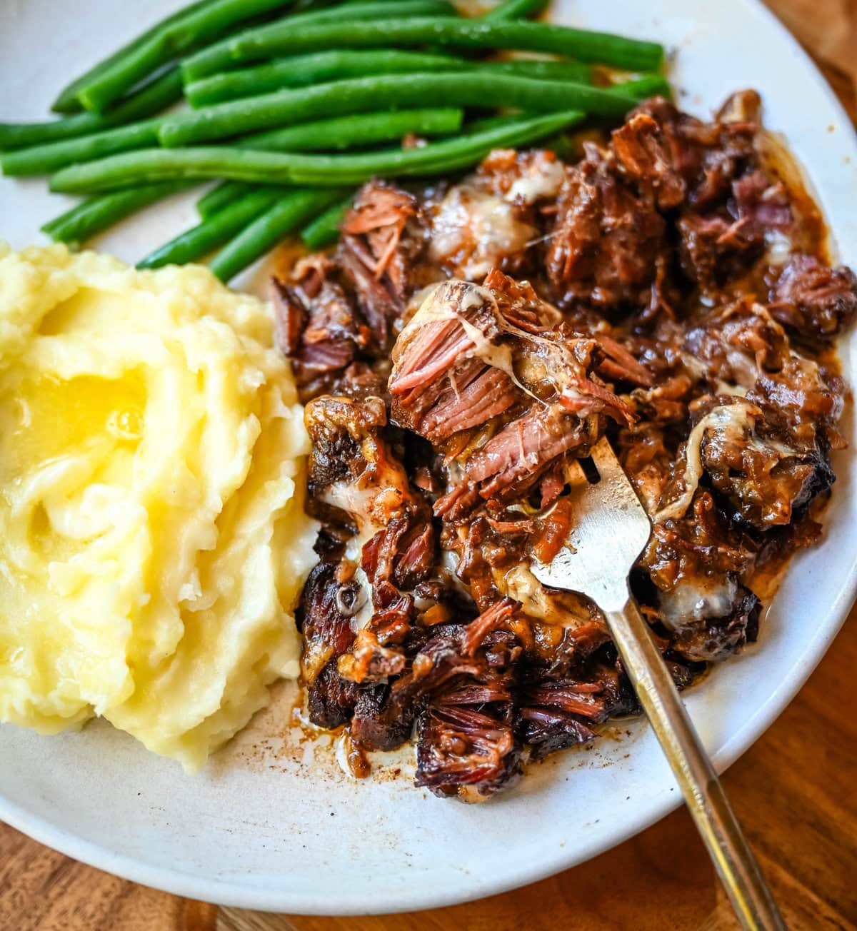 This French Onion Pot Roast recipe is made in your slow cooker for a set-it-and-forget-it meal packed with flavor. With sweet caramelized onions, beefy broth, and gooey Gruyère cheese, it's truly the best savory beef pot roast recipe!