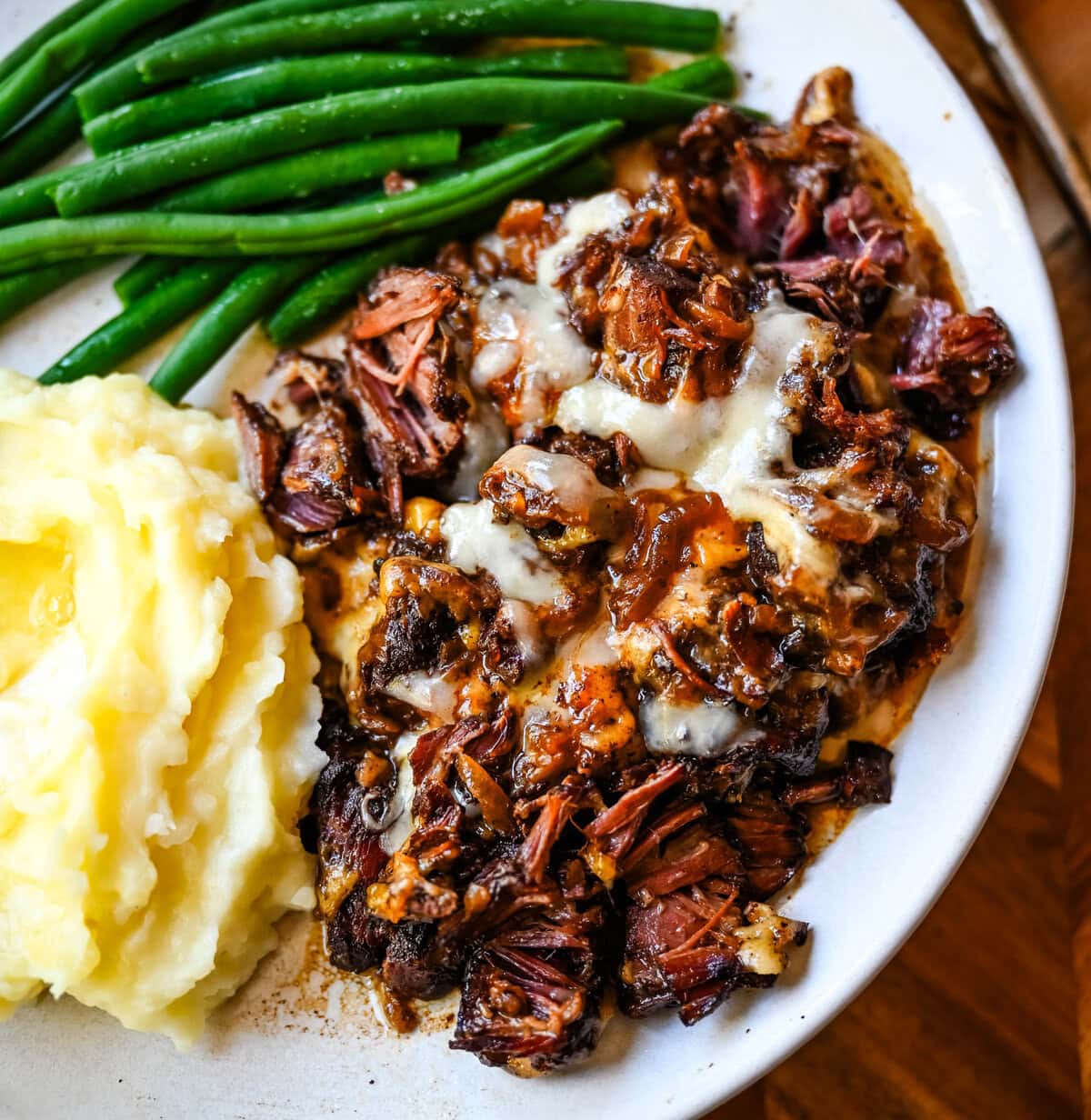 This French Onion Pot Roast recipe is made in your slow cooker for a set-it-and-forget-it meal packed with flavor. With sweet caramelized onions, beefy broth, and gooey Gruyère cheese, it's truly the best savory beef pot roast recipe!