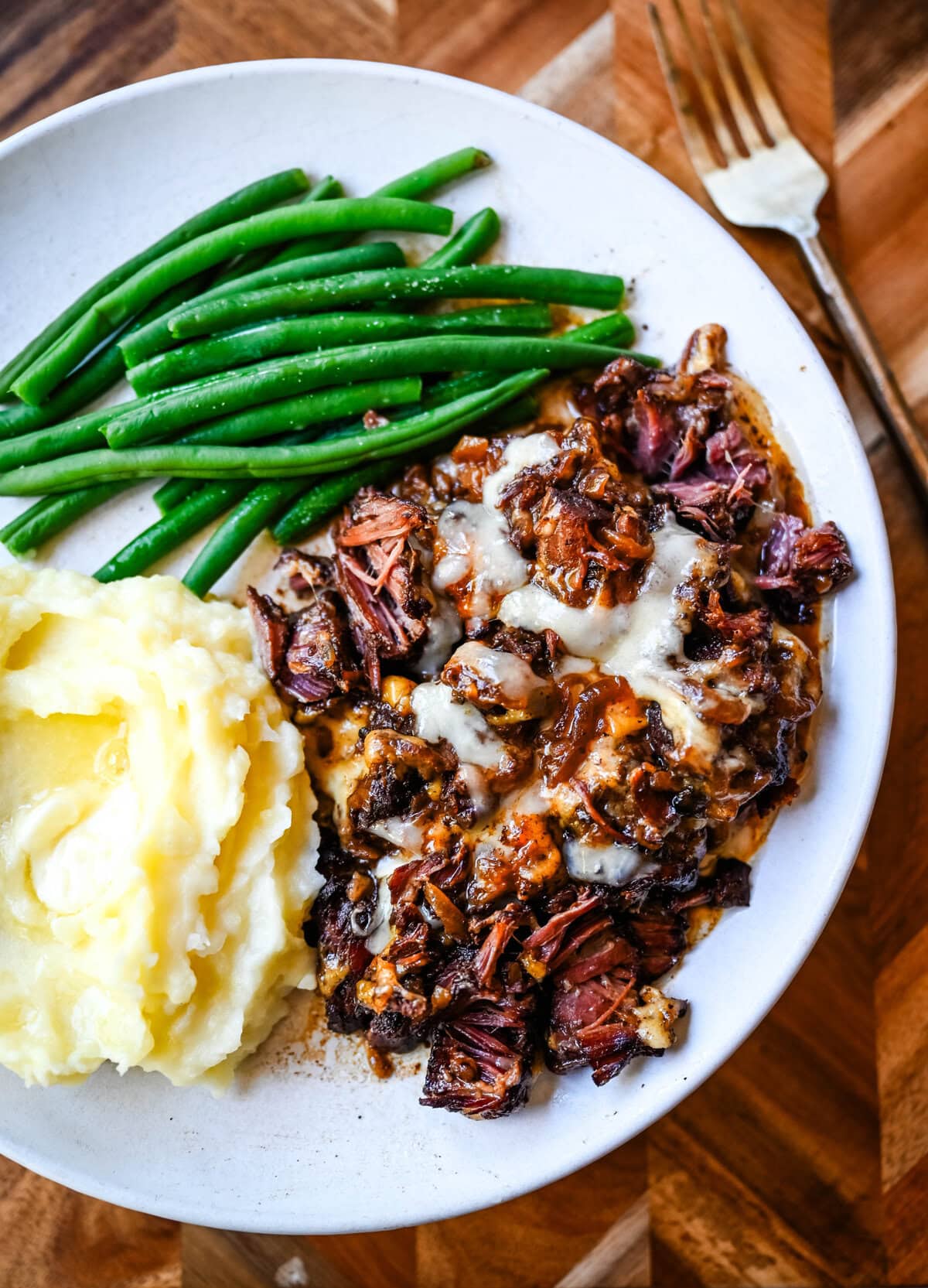 This French Onion Pot Roast recipe is made in your slow cooker for a set-it-and-forget-it meal packed with flavor. With sweet caramelized onions, beefy broth, and gooey Gruyère cheese, it's truly the best savory beef pot roast recipe!