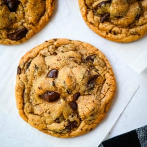 These famous Jacques Torres chocolate chip cookies are soft and chewy, and loaded with bittersweet chocolate discs. With golden edges, a soft center, and a sprinkle of sea salt on top, they’re the ultimate bakery-style chocolate chip cookies you can make at home. These are the New York Times top rated #1 chocolate chip cookie recipe.