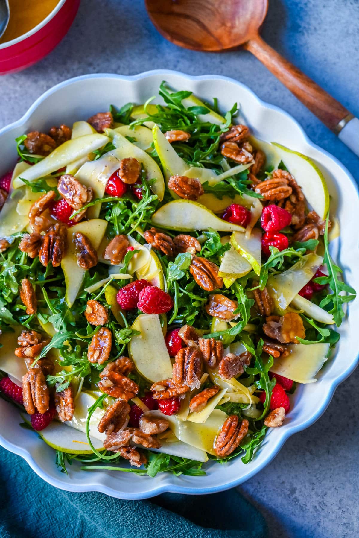 This easy arugula salad with pears and candied pecans is a show-stopping salad that’s perfect for entertaining. The delicious combination of peppery greens, sweet fruit, creamy cheese, crunchy nuts and a zesty homemade vinaigrette that ties it all together. It’s a salad that feels special enough for the holidays but simple enough for a weeknight dinner.