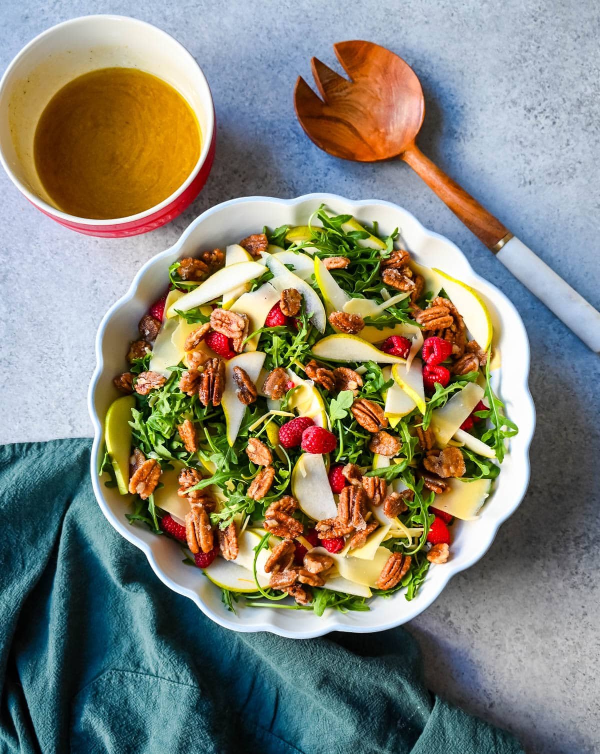 This easy arugula salad with pears and candied pecans is a show-stopping salad that’s perfect for entertaining. The delicious combination of peppery greens, sweet fruit, creamy cheese, crunchy nuts and a zesty homemade vinaigrette that ties it all together. It’s a salad that feels special enough for the holidays but simple enough for a weeknight dinner.