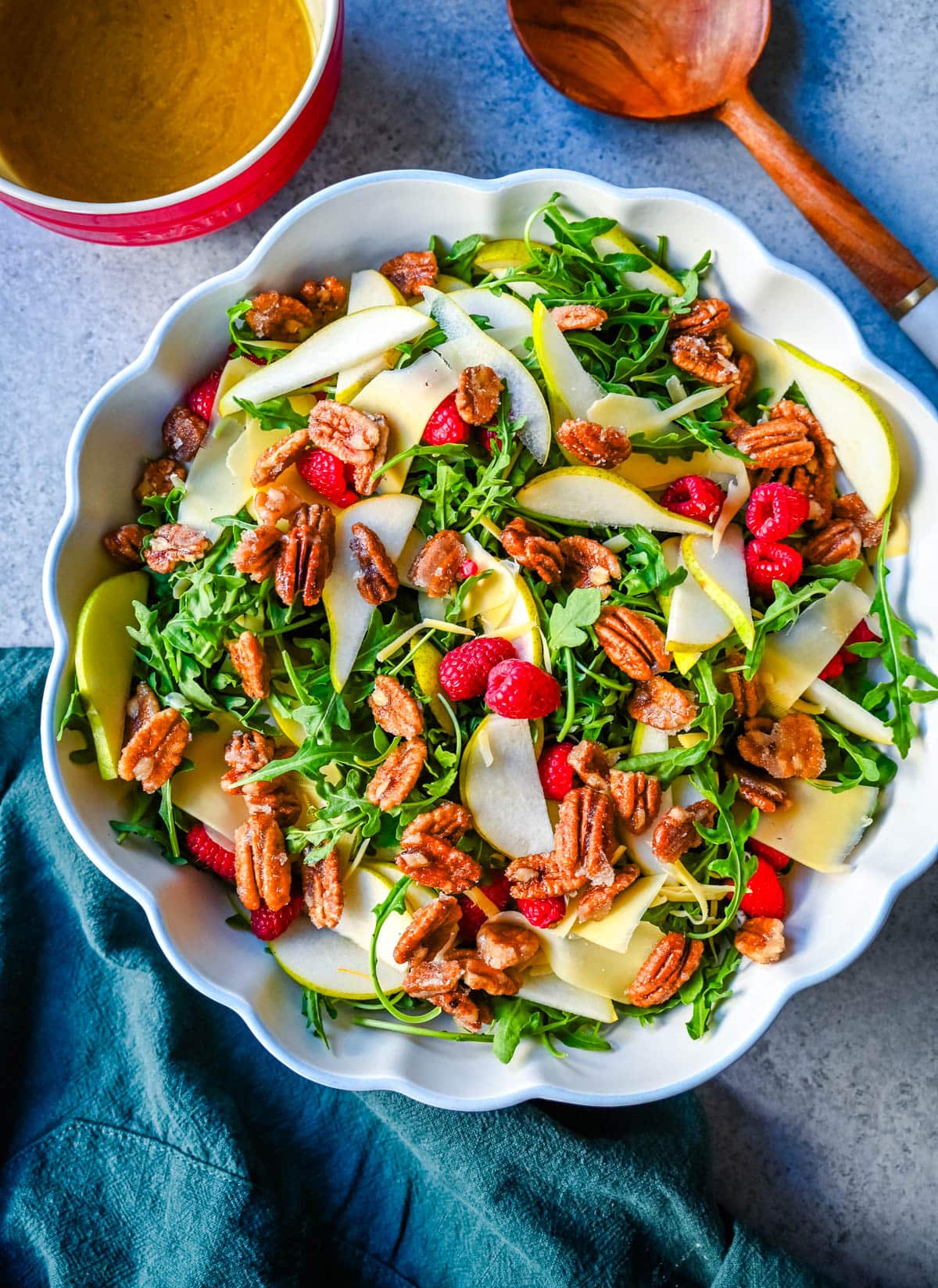 This easy arugula salad with pears and candied pecans is a show-stopping salad that’s perfect for entertaining. The delicious combination of peppery greens, sweet fruit, creamy cheese, crunchy nuts and a zesty homemade vinaigrette that ties it all together. It’s a salad that feels special enough for the holidays but simple enough for a weeknight dinner.