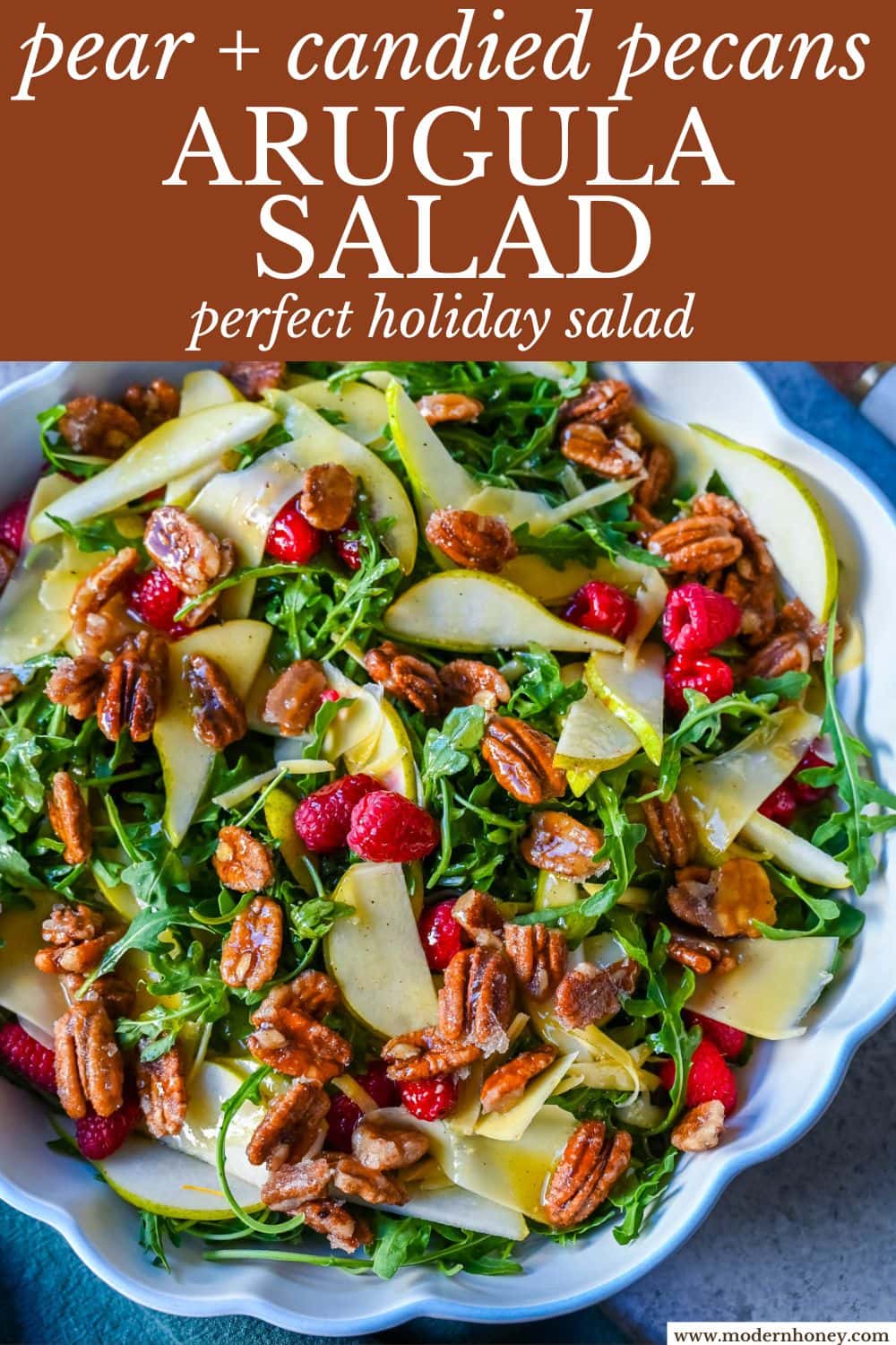 This easy arugula salad with pears and candied pecans is a show-stopping salad that’s perfect for entertaining. The delicious combination of peppery greens, sweet fruit, creamy cheese, crunchy nuts and a zesty homemade vinaigrette that ties it all together. It’s a salad that feels special enough for the holidays but simple enough for a weeknight dinner.