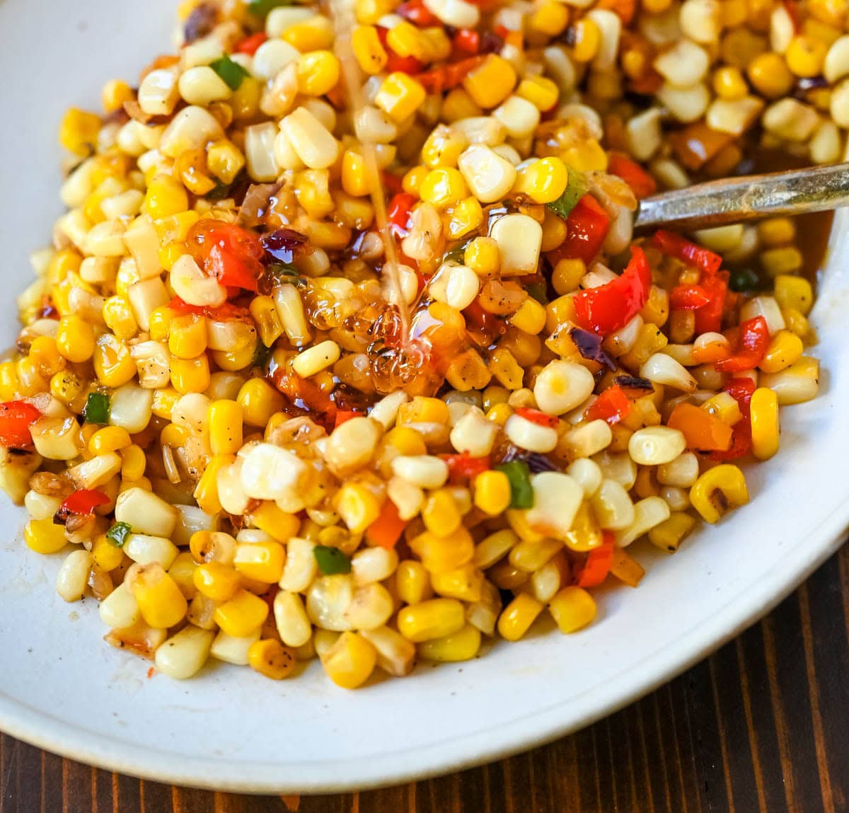This Hot Honey Skillet Corn recipe is an easy and flavorful side dish made with sweet corn, peppers, onions, and spicy hot honey. It’s a quick corn recipe that's ready in under 20 minutes and pairs perfectly with roasted turkey or chicken.
