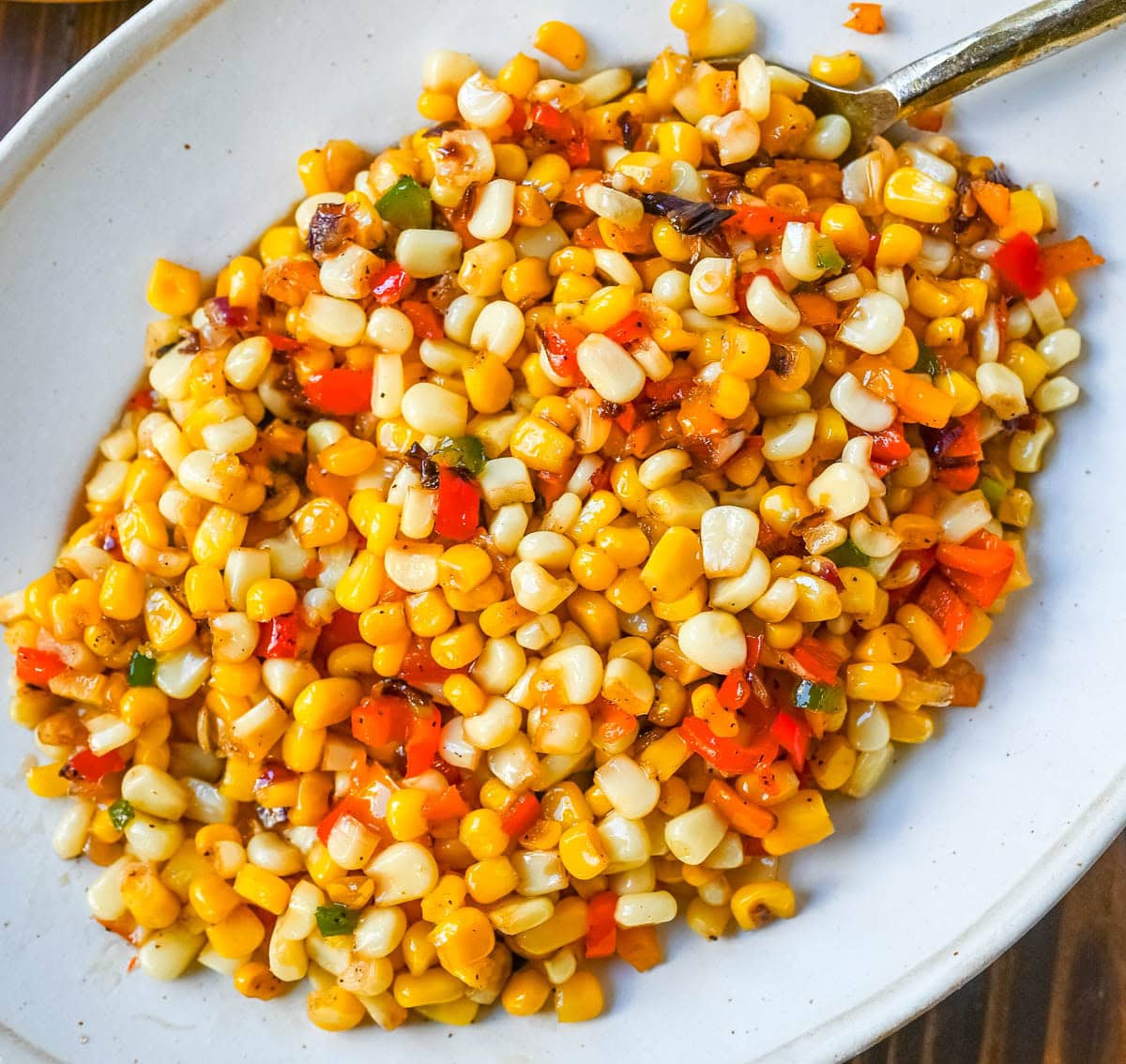 This Hot Honey Skillet Corn recipe is an easy and flavorful side dish made with sweet corn, peppers, onions, and spicy hot honey. It’s a quick corn recipe that's ready in under 20 minutes and pairs perfectly with roasted turkey or chicken.