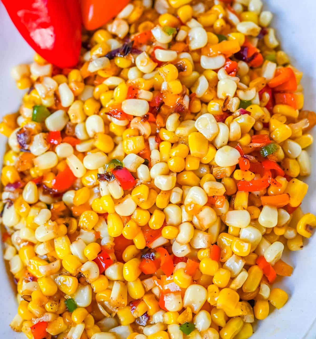 This Hot Honey Skillet Corn recipe is an easy and flavorful side dish made with sweet corn, peppers, onions, and spicy hot honey. It’s a quick corn recipe that's ready in under 20 minutes and pairs perfectly with roasted turkey or chicken.